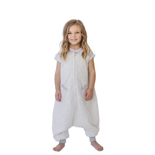 A baby standing comfortably in a Tealbee Dreamsuit, featuring buttery soft and cozy fabric made of 70% Bamboo Rayon and 30% Organic Cotton. Designed as a sleep sack with feet for walkers, ensuring both comfort and safety.