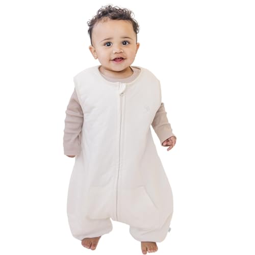 A baby standing comfortably in a Tealbee Dreamsuit, featuring buttery soft and cozy fabric made of 70% Bamboo Rayon and 30% Organic Cotton. Designed as a sleep sack with feet for walkers, ensuring both comfort and safety.