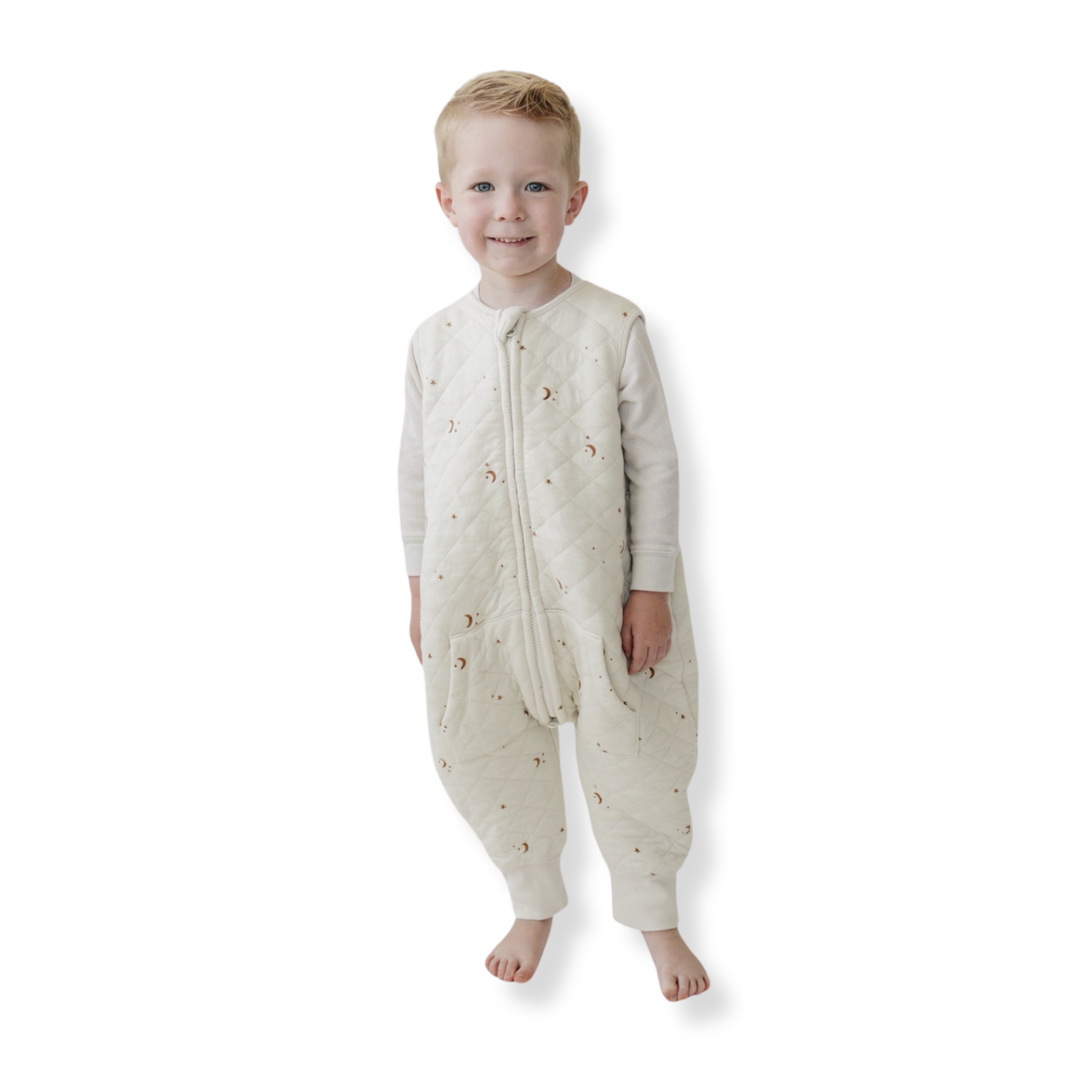 A baby standing comfortably in a Tealbee Dreamsuit, featuring buttery soft and cozy fabric made of 70% Bamboo Rayon and 30% Organic Cotton. Designed as a sleep sack with feet for walkers, ensuring both comfort and safety.