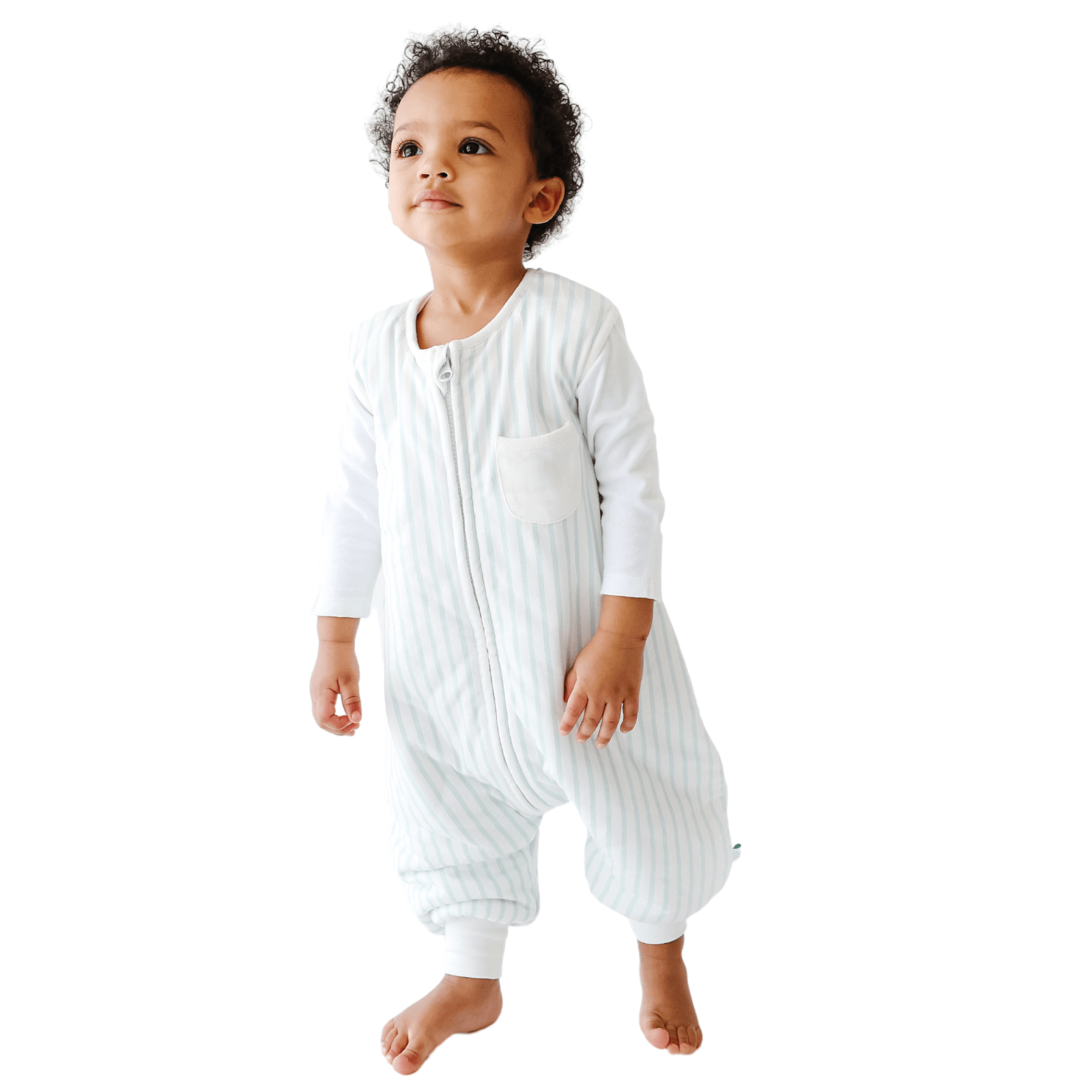 A baby standing comfortably in a Tealbee Dreamsuit, featuring buttery soft and cozy fabric made of 70% Bamboo Rayon and 30% Organic Cotton. Designed as a sleep sack with feet for walkers, ensuring both comfort and safety.