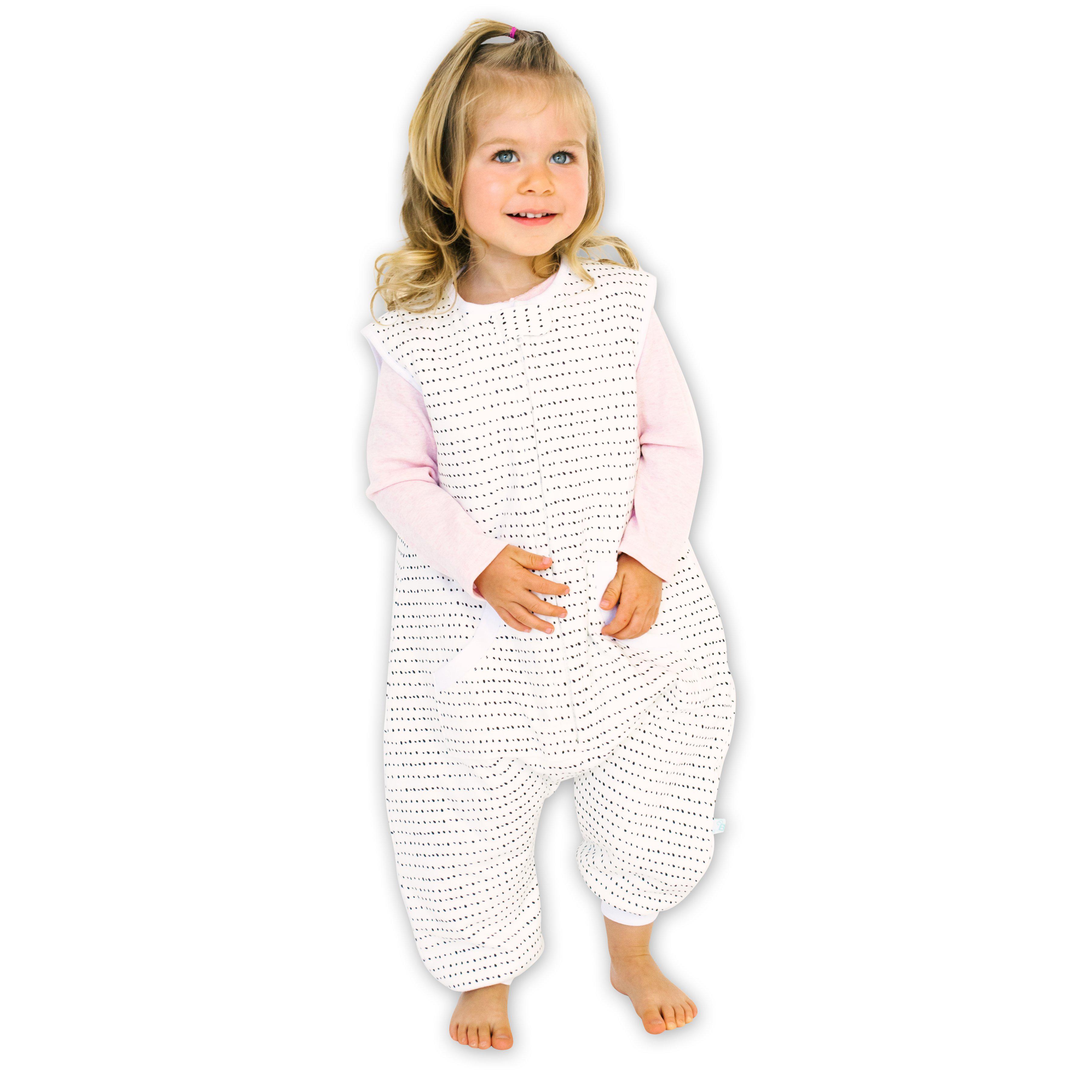 A baby standing comfortably in a Tealbee Dreamsuit, featuring buttery soft and cozy fabric made of 70% Bamboo Rayon and 30% Organic Cotton. Designed as a sleep sack with feet for walkers, ensuring both comfort and safety.