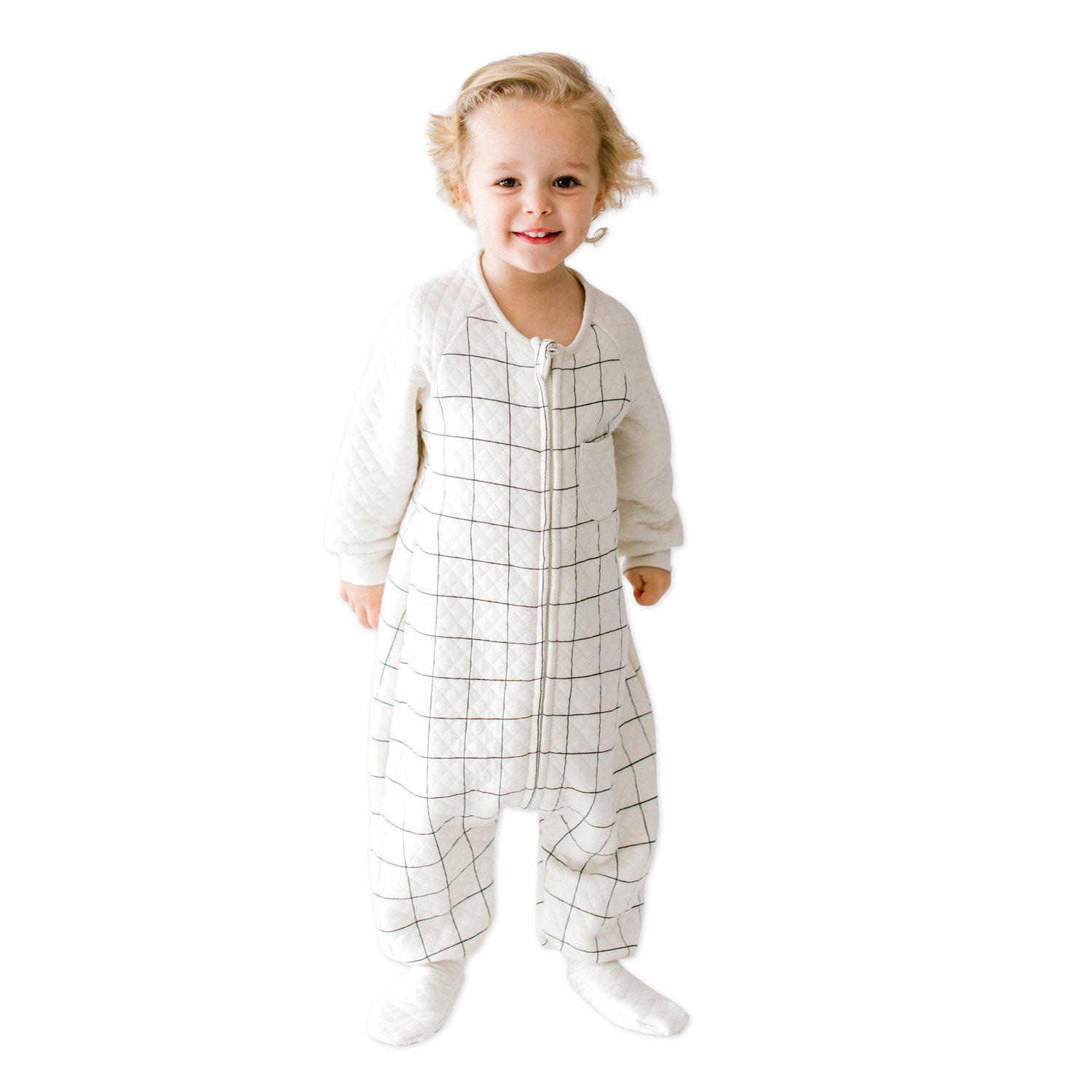A baby standing up comfortably in a Tealbee Dreamsie, highlighting the perfect combination of warmth, coziness, and freedom of movement for a happy, restful sleep.