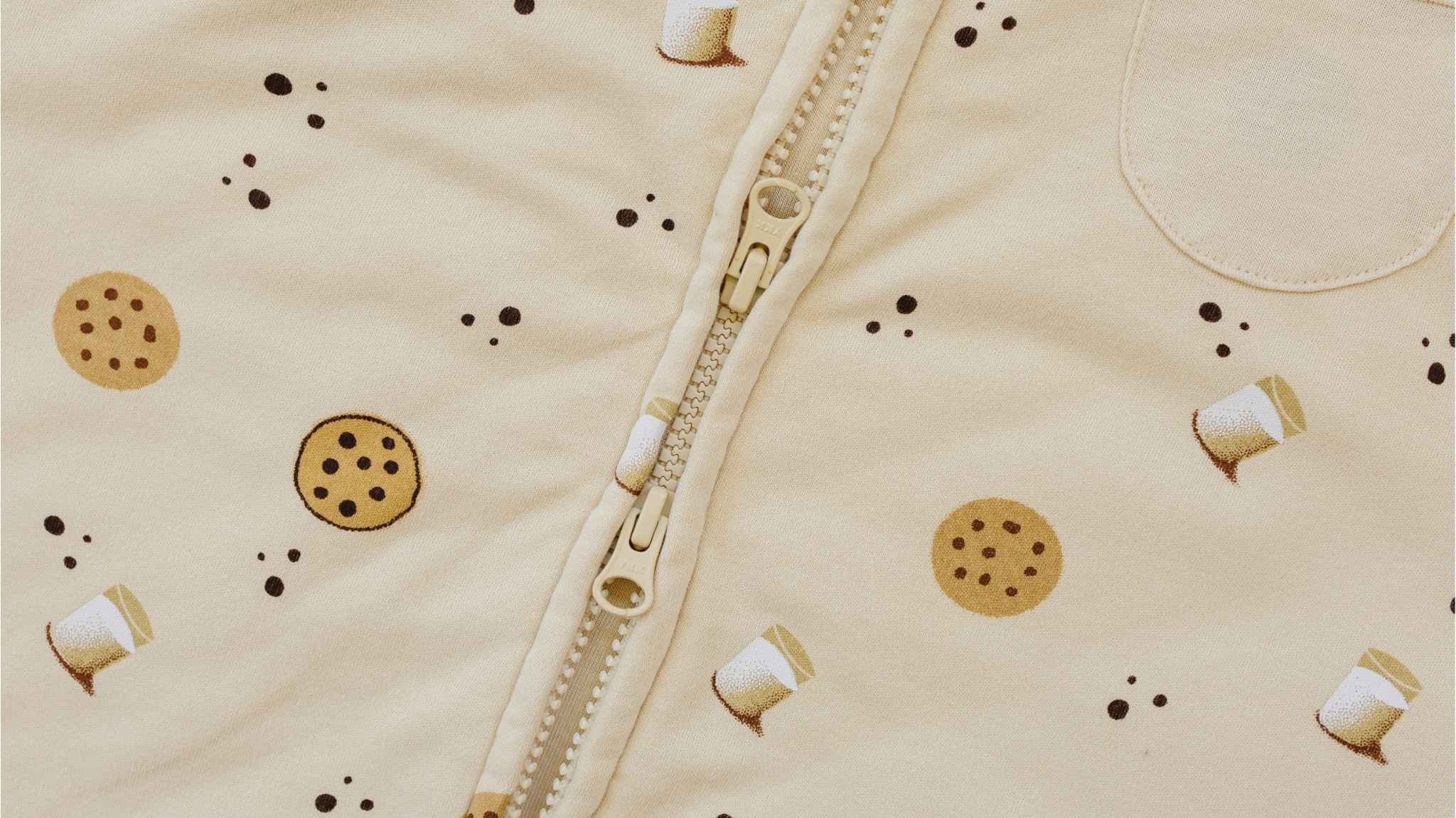 Close-up of double zipper, two-way zipper on tealbee dreamsuit in Cookies print