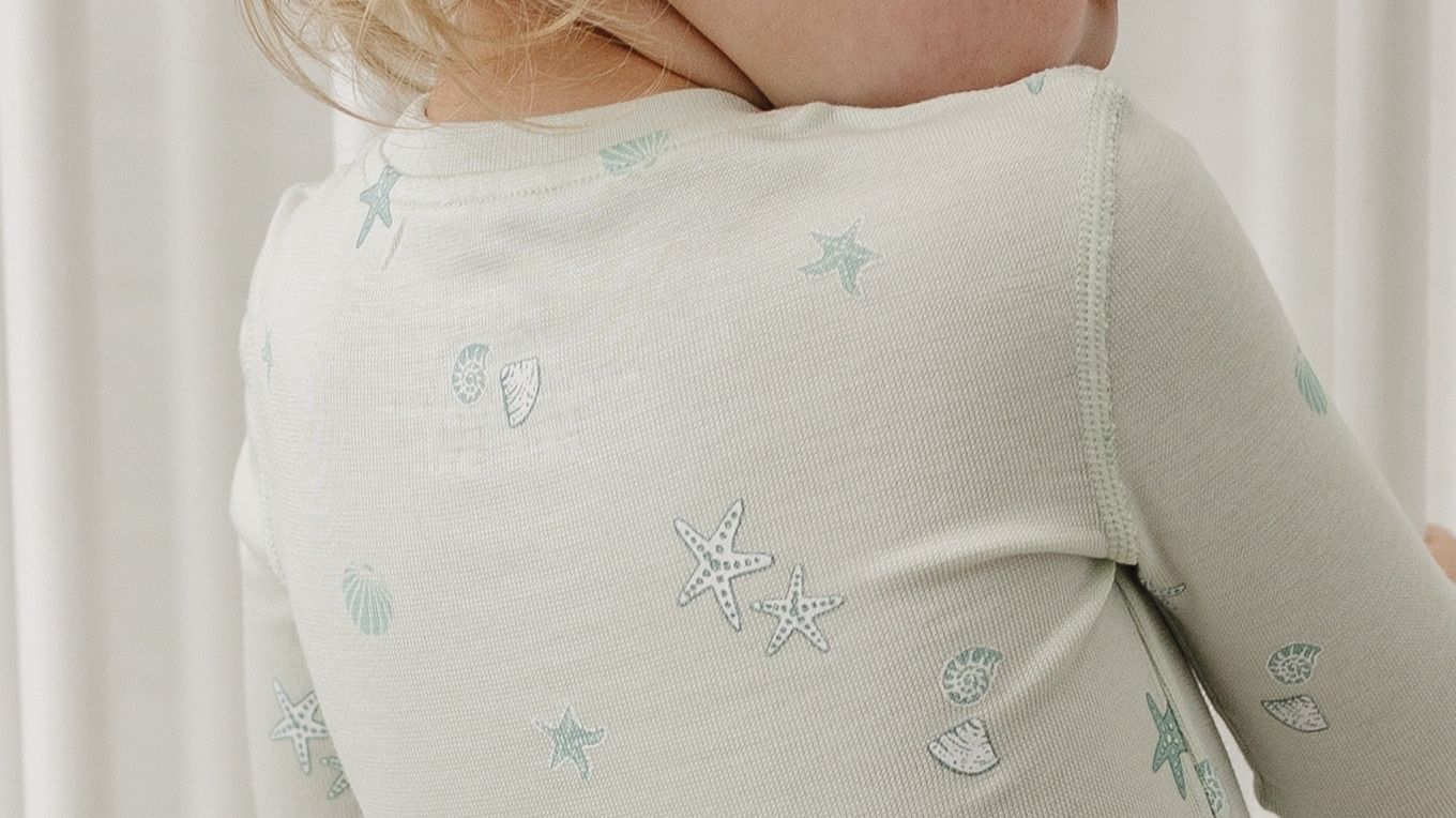 Close up of fabric, flat seam and tagless design of tealbee pajama in seashell print