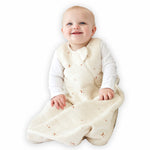A baby sitting down comfortably in a Tealbee Dreambag 1.2 TOG, highlighting the perfect combination of warmth, coziness, and freedom of movement for a happy, restful sleep.