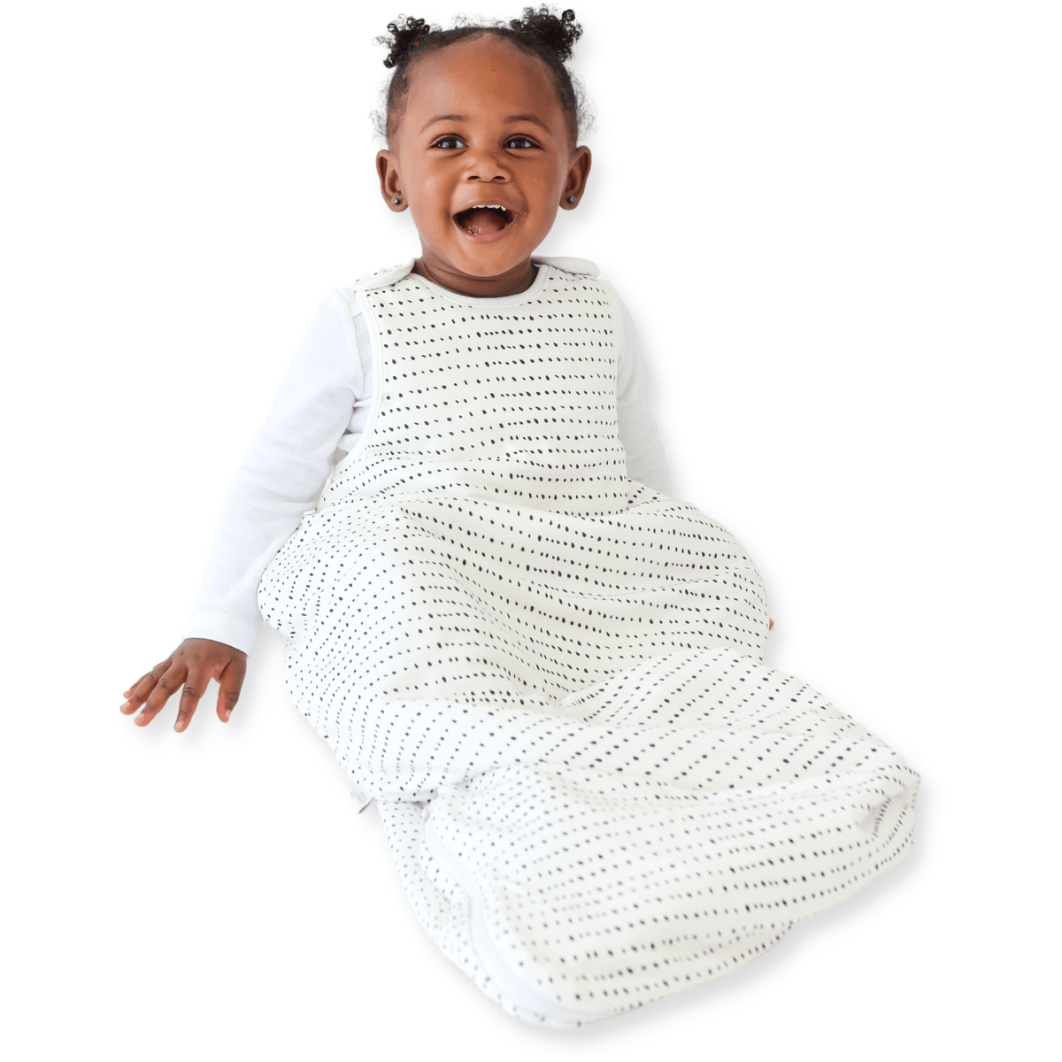 A baby sitting down comfortably in a Tealbee Dreambag 1.5 TOG, highlighting the perfect combination of warmth, coziness, and freedom of movement for a happy, restful sleep.