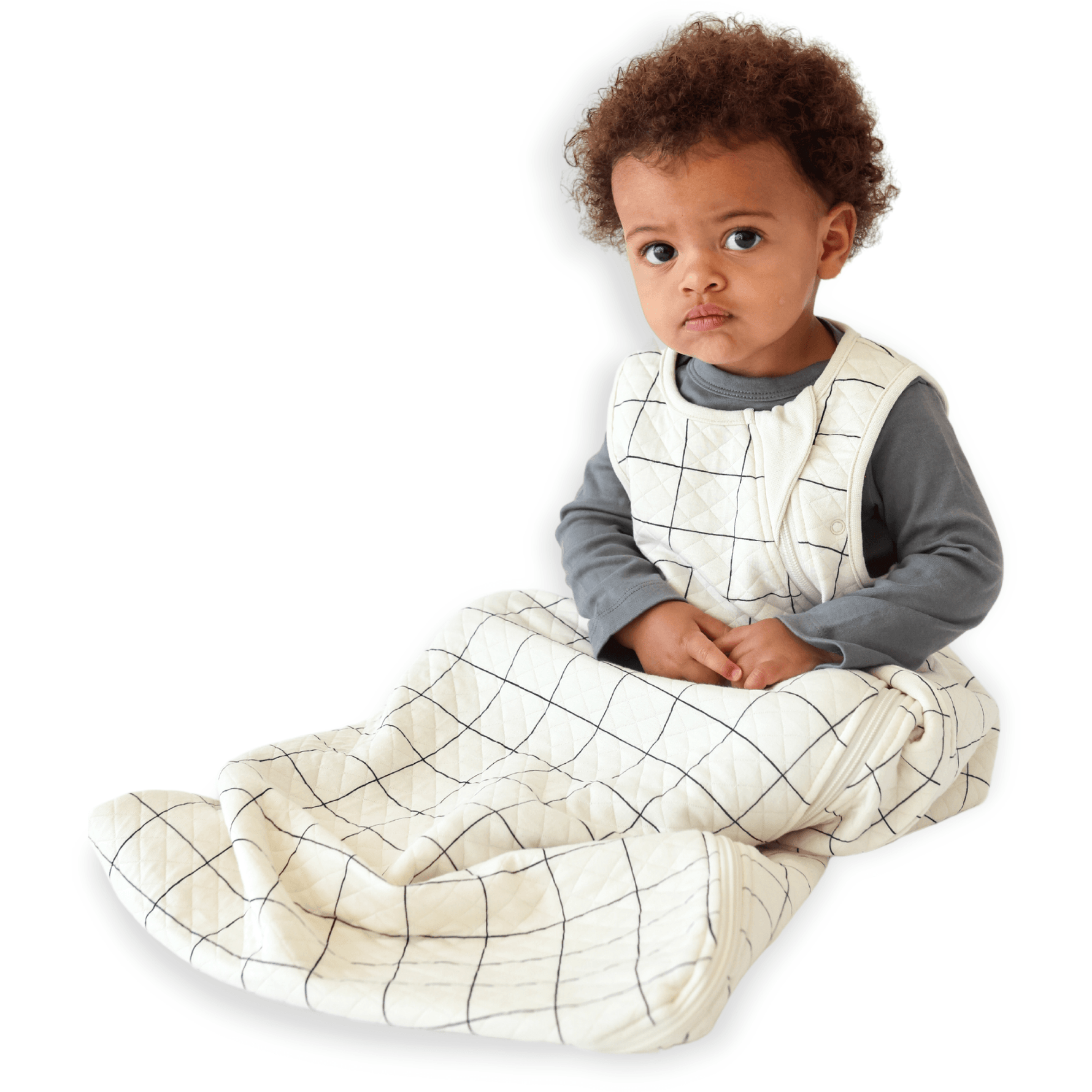A baby sitting down comfortably in a Tealbee Dreambag 1.2 TOG, highlighting the perfect combination of warmth, coziness, and freedom of movement for a happy, restful sleep.