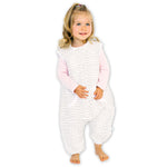 A baby standing comfortably in a Tealbee Dreamsuit, featuring buttery soft and cozy fabric made of 70% Bamboo Rayon and 30% Organic Cotton. Designed as a sleep sack with feet for walkers, ensuring both comfort and safety.